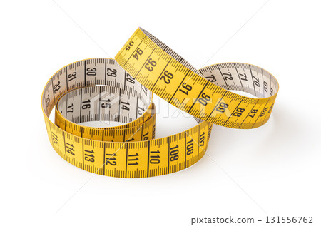 Yellow measuring tape curled and showing numbers for measuring length 131556762