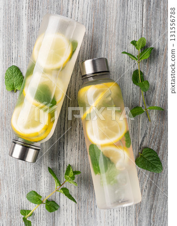 Refreshing summer drink with lemon and mint infused water bottles Refreshing summer drink with lemon and mint infused water bottles 131556788