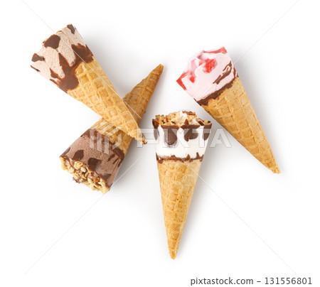 Ice cream cones with chocolate and strawberry topping lying on white background 131556801