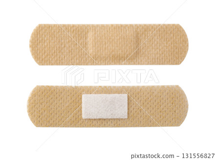 Two adhesive bandages on white background showing front and back Two adhesive bandages on white background showing front and back 131556827