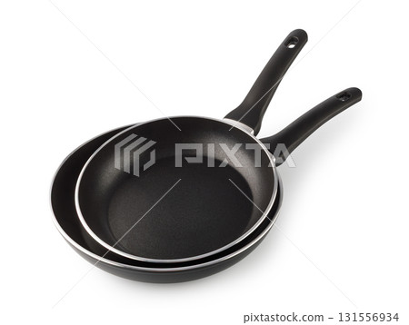 Two black frying pans with non-stick coating on transparent background Two black frying pans with non-stick coating on transparent background 131556934
