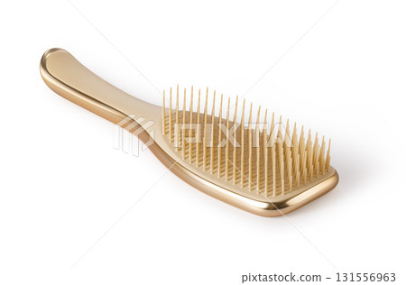 Golden hairbrush with plastic bristles lying on transparent background 131556963