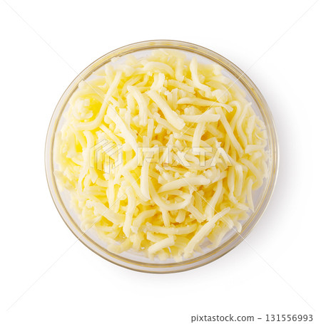 Grated cheese overflowing a glass bowl on white background Grated cheese overflowing a glass bowl on white background 131556993