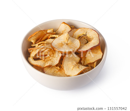 Dried apple slices in bowl, healthy vegan snack 131557042
