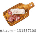 Salami, sausage slices lying on wooden cutting board 131557108