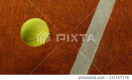 Freeze Motion Detail Shot of Tennis Ball Hitting a Clay Court Freeze Motion Detail Shot of Tennis Ball Hitting a Clay Court 131557176