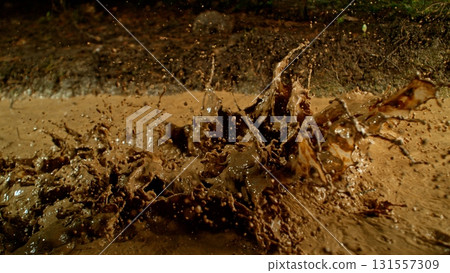 Freeze Motion Shot of Mud Splashing , Side View Freeze Motion Shot of Mud Splashing , Side View 131557309