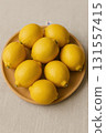 Fresh lemons on wooden plate 131557415