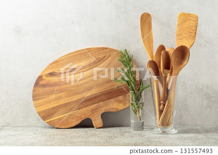 Wooden kitchen utensils and rosemary. 131557493