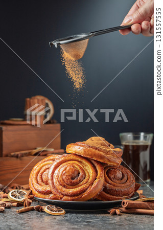Kanelbullar. Freshly baked buns sprinkled with cinnamon. 131557555