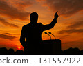 Silhouette of a man raising his hand in the sunset 131557922