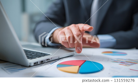financial consultant pointing at pie chart on laptop financial consultant pointing at pie chart on laptop 131559276