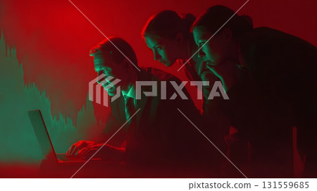 Investors leaning over unstable laptop screen glowing red green Investors leaning over unstable laptop screen glowing red green 131559685