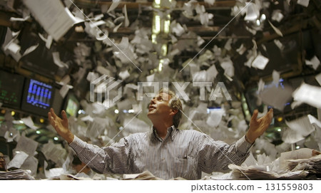 Trader throwing papers in air after loss 131559803