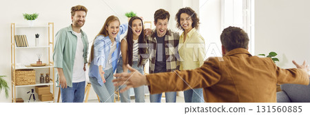 Group of happy men and women having a reunion with a friend they haven't seen for a long time 131560885