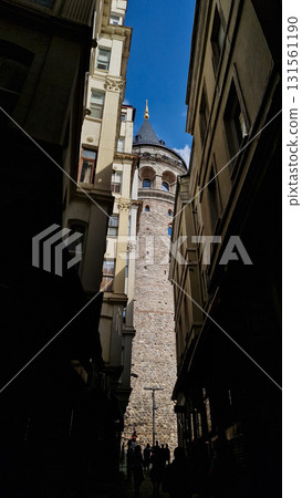 Istanbul, Turkey. View of Galata tower through the streets with tight buildings. Travel attraction. Islamic architecture  Istanbul, Turkey. View of Galata tower through the streets with tight buildings. Travel attraction. Islamic architecture  131561190