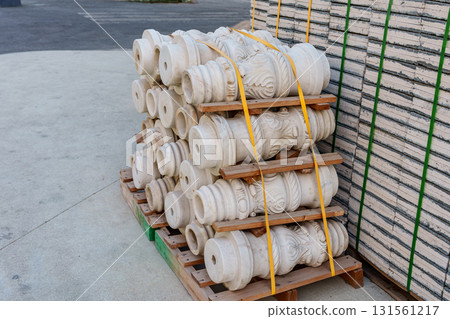 Pallets with stacked gray paving slabs selective focus Stack of paving slabs in warehouse road repair or finished tile sale space for text. High quality photo Pallets with stacked gray paving slabs selective focus Stack of paving slabs in warehouse road repair or finished tile sale space for text. High quality photo 131561217