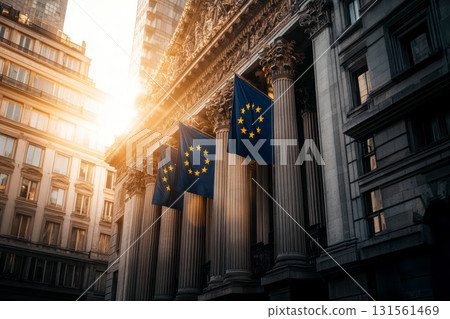A large European flag hangs finance buildings in a city, with sunlight streaming down. finance bankruptcy concept. 131561469