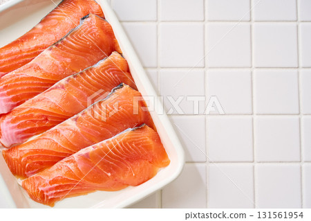 Raw salmon fillets | Cooking ingredients arranged on a white tray (tile background) 131561954