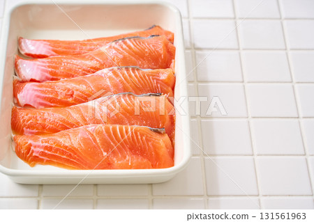 Raw salmon fillets | Cooking ingredients arranged on a white tray (tile background) 131561963