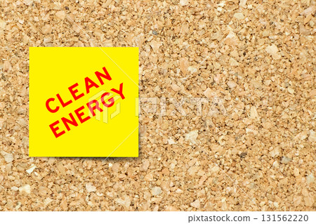 Yellow note paper with word clean energy on cork board background with copy space 131562220