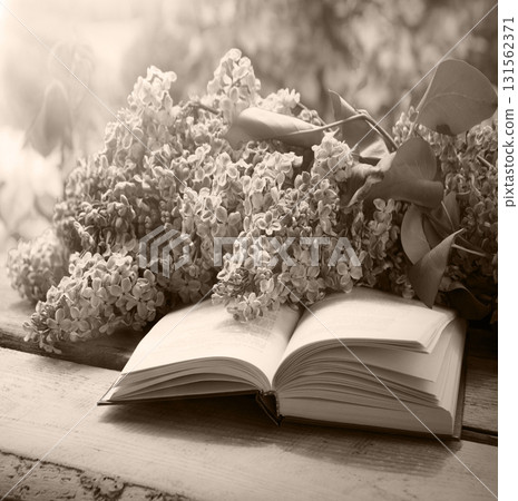 Lilac and book on the table Lilac and book on the table 131562371