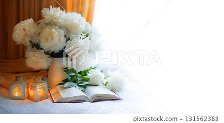 Flowers and book on the table 131562383