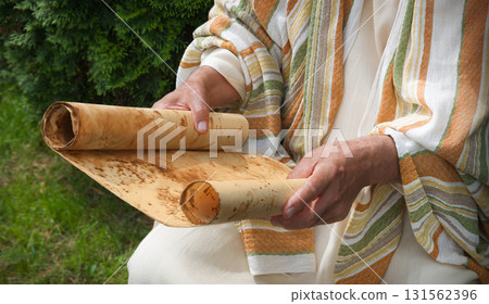 Old man reading the scroll Old man reading the scroll 131562396