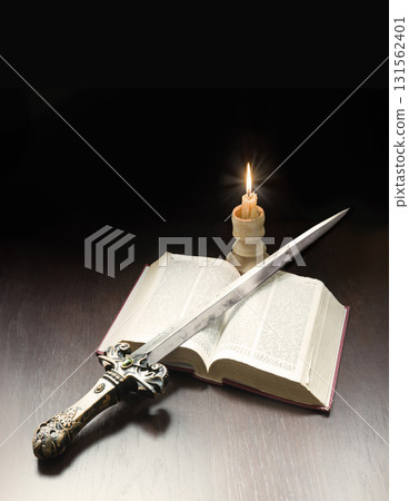 Old book and sword on the table 131562401