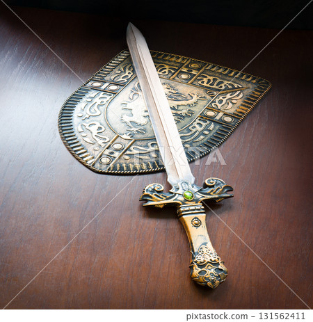 Iron shield and sword on the table Iron shield and sword on the table 131562411