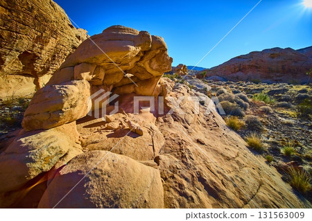 Sandstone Formations and Desert Vegetation under Bright Blue Sky Sandstone Formations and Desert Vegetation under Bright Blue Sky 131563009