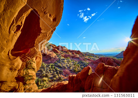 Red Sandstone Arch Formation and Desert Landscape with Sunburst Red Sandstone Arch Formation and Desert Landscape with Sunburst 131563011