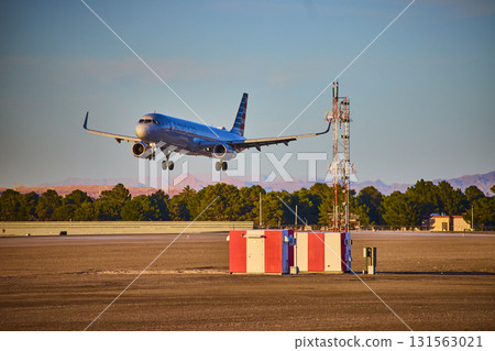 Airplane taxiing at Las Vegas airport with city skyline and Nevada mountains in background 131563021