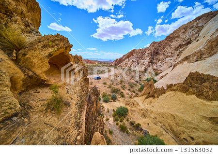 Desert Road and Sandstone Formations with Car in Gold Butte National Monument 131563032