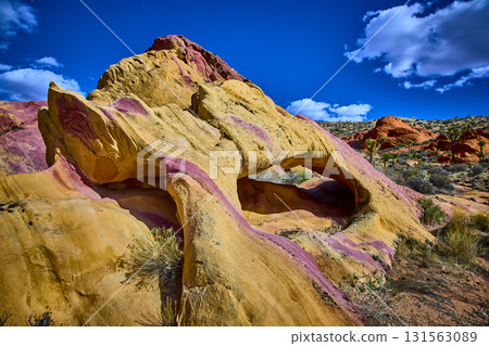 Colorful Neapolitan Arch Formation in Desert Landscape Under Vibrant Blue Sky Colorful Neapolitan Arch Formation in Desert Landscape Under Vibrant Blue Sky 131563089