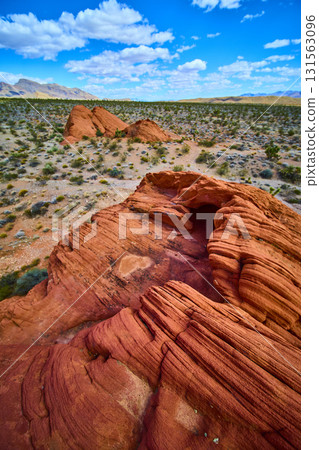 Red Sandstone Formations and Desert Landscape Under Vibrant Blue Sky Red Sandstone Formations and Desert Landscape Under Vibrant Blue Sky 131563096