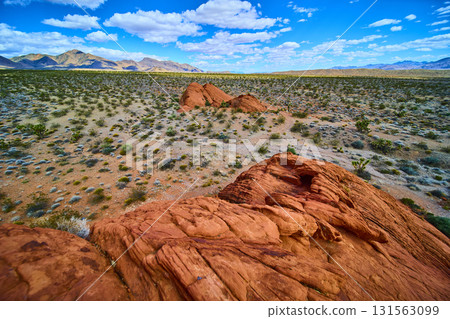 Red Sandstone Formations and Desert Landscape Under Blue Sky 131563099