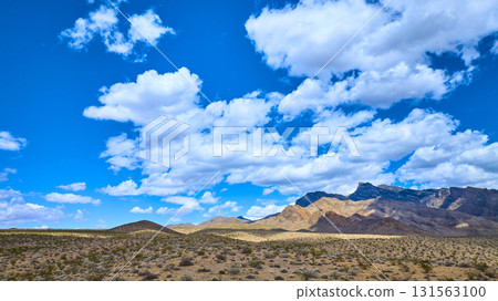 Desert Landscape With Rugged Mountains And Expansive Blue Sky Desert Landscape With Rugged Mountains And Expansive Blue Sky 131563100