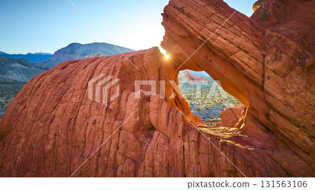 Sunburst Through Red Rock Arch Formation At Gold Butte National Monument 131563106