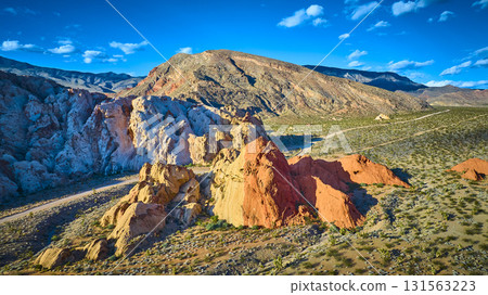Aerial Dramatic Red and White Rock Formations Desert Landscape and Mountains 131563223