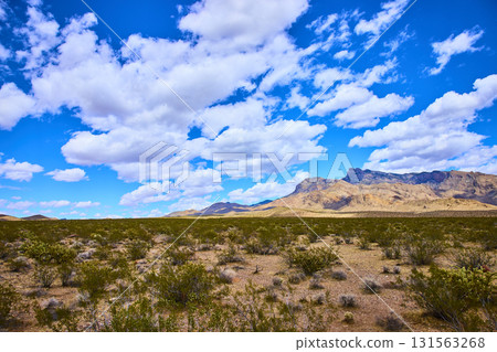 Desert Landscape with Mountain Ridge and Dramatic Cloud Filled Sky Desert Landscape with Mountain Ridge and Dramatic Cloud Filled Sky 131563268