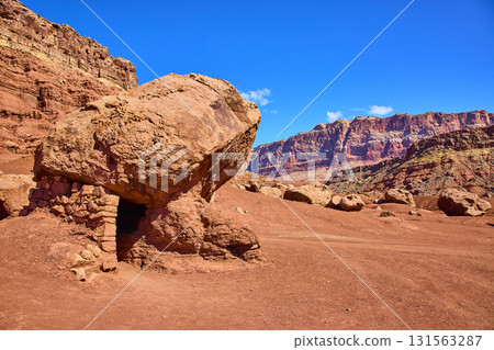 Red Boulder Shelter and Sandstone Cliffs in Marble Canyon Arizona Daylight 131563287