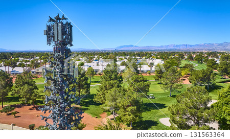 Aerial Camouflaged Cell Tower Over Golf Course and Residential Community 131563364
