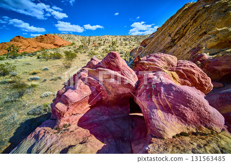 Colorful Sandstone Arch Formation and Desert Landscape Under Vibrant Blue Sky Colorful Sandstone Arch Formation and Desert Landscape Under Vibrant Blue Sky 131563485
