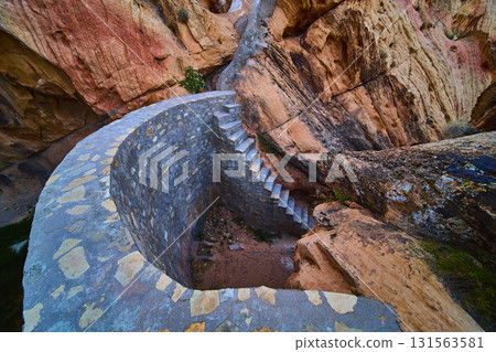 Stone Cistern and Staircase Nestled in Desert Sandstone Cliffs 131563581