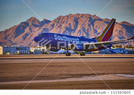 Airplane taxiing at Las Vegas airport Nevada with city skyline and mountains in background Airplane taxiing at Las Vegas airport Nevada with city skyline and mountains in background 131563605