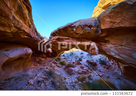 Sandstone Arch Formation Framed by Desert Landscape and Blue Sky Sandstone Arch Formation Framed by Desert Landscape and Blue Sky 131563672