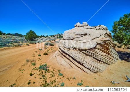 Sandstone Rock Formation and Desert Road in Sunlit Vermilion Cliffs Arizona 131563704