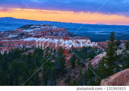 Bryce Canyon Hoodoos and Pine Trees at Sunrise with Vibrant Golden Hour Sky 131563915