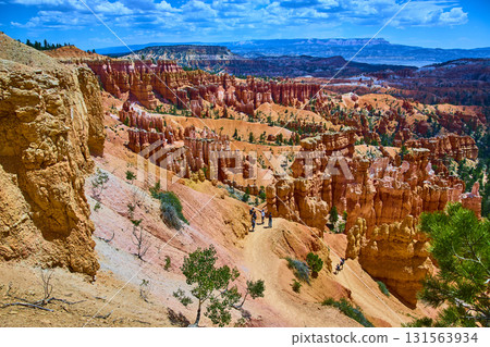 Bryce Canyon Hoodoos Trail Hikers and Dramatic Rock Formations Under Blue Sky 131563934